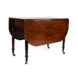 A Victorian mahogany drop leaf dining table on turned legs,