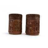 A pair of carved bamboo covered boxes of typical cylindrical form, each decorated with exotic birds,