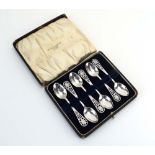 A cased set of six silver teaspoons with pierced and brightcut engraved ends, maker Thomas Bradbury,