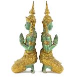 A pair of Far Eastern green patinated and gilt decorated bronze figures modelled as a couple at