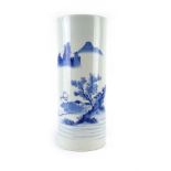 A Chinese blue and white brush pot of cylindrical form, decorated with a traditional landscape, h.