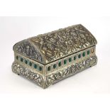 An Arts & Crafts style hammered pewter box of sarcophagus form, decorated with green roundel's,
