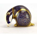A Royal Crown Derby paperweight in the form of a resting badger, h. 7.