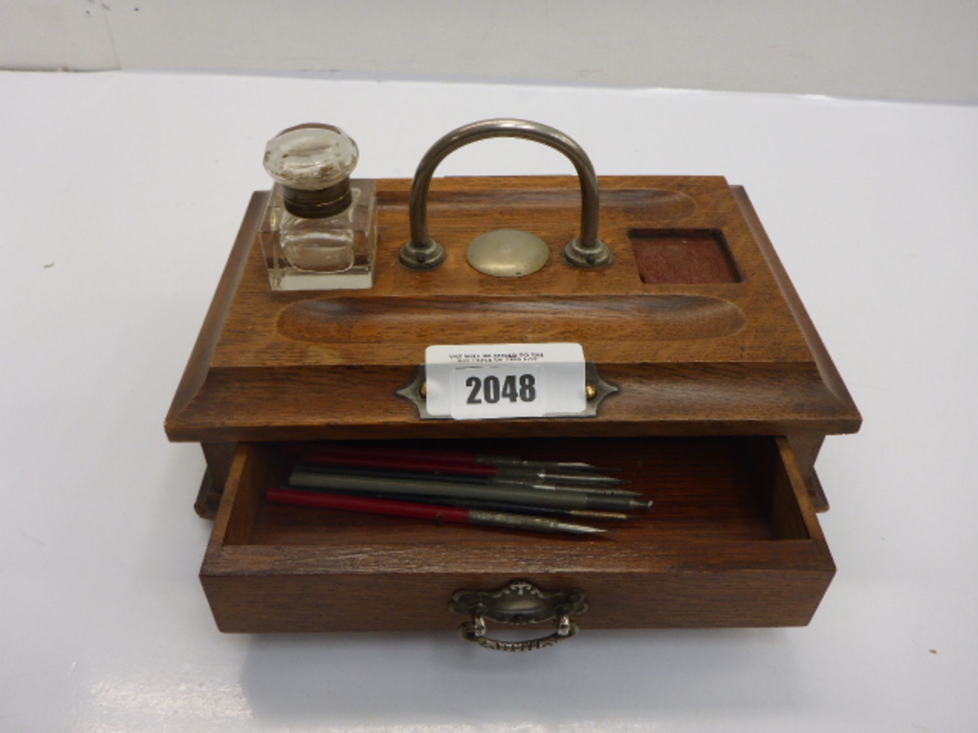 Wooden desk companion with drawer and inkwell .