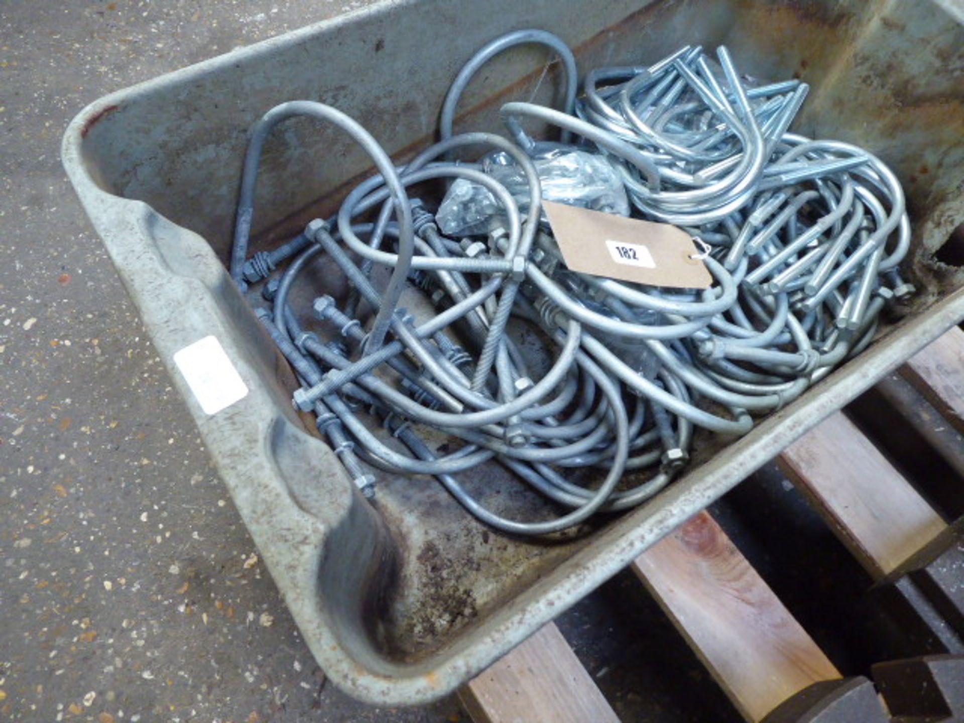 Plastic bin containing U bolts and nuts