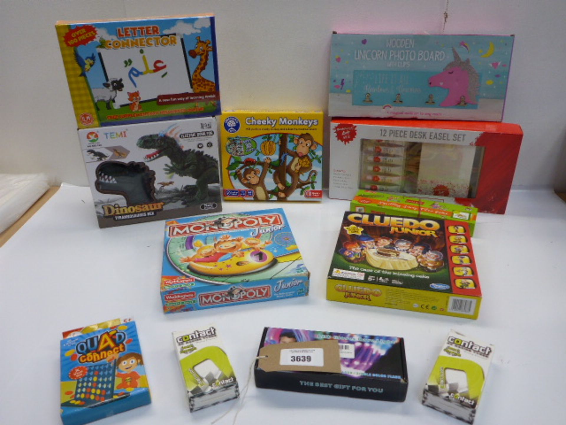 12 boxed games including Letter Connector, Dinosaur T-Rex, Junior Monopoly, Cludo Junior, Cheeky