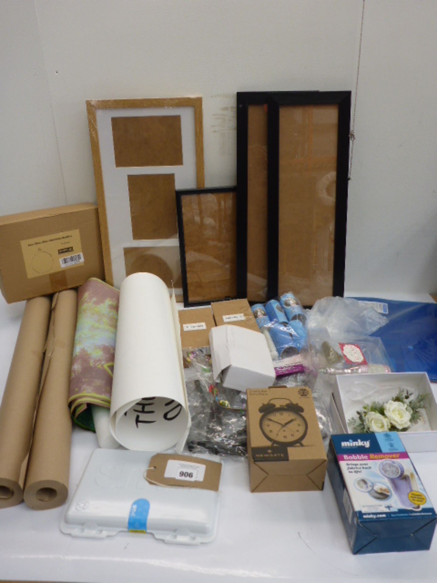 Picture frames, brown parcel paper, posters, alarm clock, lint rollers, bobble remover and household