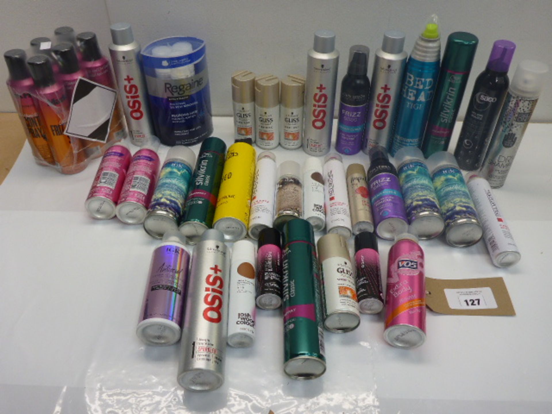 Bag containing hair products including hair spray, mousse, dry shampoo, frizz control spray, shine