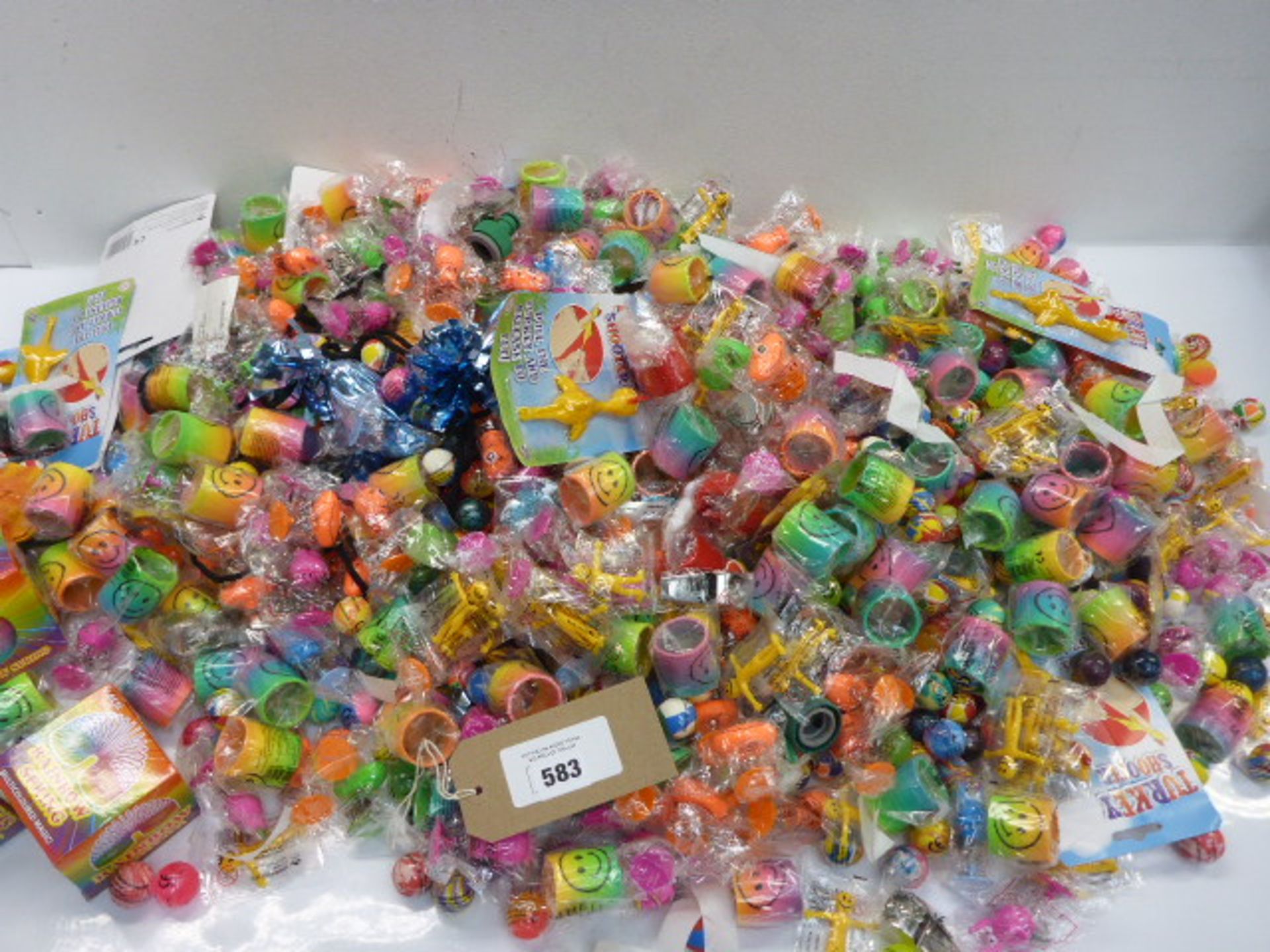 Large bag of novelty toys, bouncy balls, Turkey shooters, whistles, rainbow springs, pop up