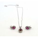 A 9ct white gold finelink necklace suspending a teardrop pendant set ruby and diamonds,