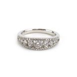 An 18ct white gold ring set nine graduated brilliant cut diamonds within a diamond set split band,