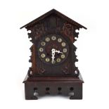 A Black Forest-type cuckoo clock, the movement striking on a gong, the face with Arabic numerals,