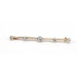 An early 20th century yellow metal bar brooch set five old cut diamonds,