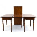 A late 18th/early 19th century mahogany extending dining table having a pair of d-end sections and