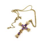 A 14ct yellow gold ropetwist necklace suspending a 14ct yellow gold pendant of cross form set five