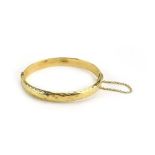 A 9ct yellow gold florally engraved hinged bracelet, Birmingham 1992, 10.