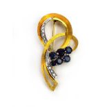 An 18ct yellow gold brooch of openwork spray form set six graduated sapphires and small diamonds,