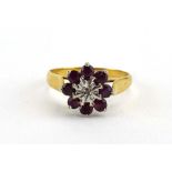 An 18ct yellow gold flowerhead ring set small diamond and eight garnets, ring size R, 3.