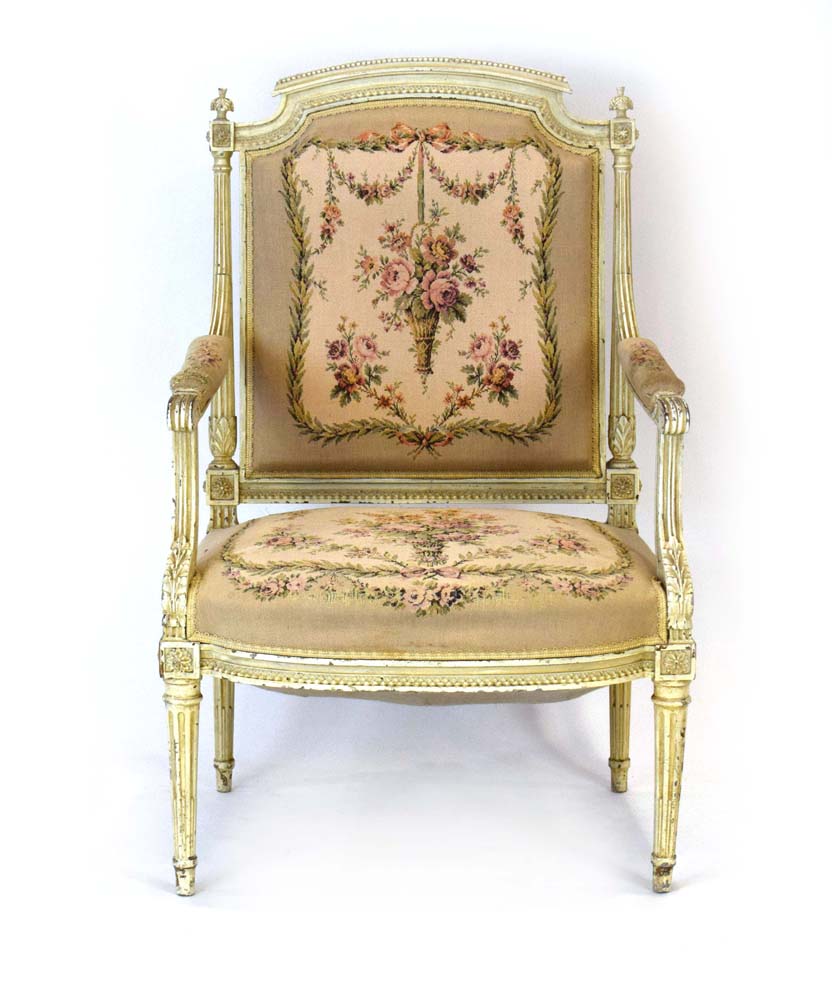 A Louis XVI-style cream and gilt highlighted salon armchair with a floral upholstered seat and back