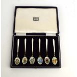 A cased set of six silver gilt and enamelled teaspoons, each bowl decorated with a floral spray,