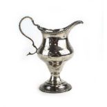 A George III silver cream jug of vase shaped form, maker EM, London 1780,