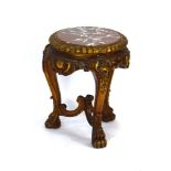 A late 19th/early 20th century French giltwood table with a circular marble surface,