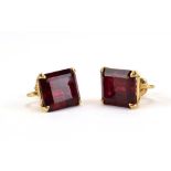 A pair of 14ct yellow gold screw-type earrings, each set a baguette cut red coloured stone, l. 1.