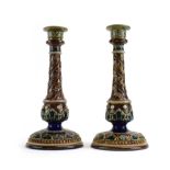 A pair of Royal Doulton stoneware candlesticks of wrythen form typically relief decorated with