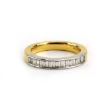 An 18ct yellow gold and platinum highlighted half eternity ring set baguette cut diamonds in a