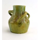 A studio pottery three handled vase decorated in a plain green drip glaze in the manner of Ault, h.