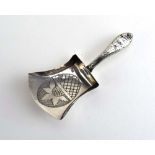 A George III engraved silver caddy spoon of shovel form, maker IT, Birmingham 1811, l. 7.