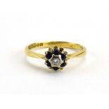 An 18ct yellow gold cluster ring set small diamond in a surround of six sapphires, ring size M 1/2,