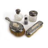 Five early 20th century silver mounted dressing table items,