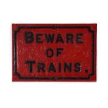 A cast iron 'Beware of Trains' sign,