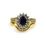 An 18ct yellow gold sapphire and diamond cluster ring, the shoulders each set four small diamonds,