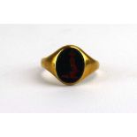 An 18ct yellow gold signet ring set green hardstone, maker CG&S, Birmingham 1915, ring size P, 5.