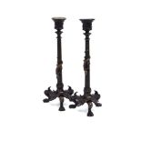 A pair of bronzed candlesticks, each with a lizard crawling over the shaft, on three claw feet, h.