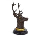 An early 20th century bronze inkwell modelled as a stag's head, on a gilt metal and marble plinth,