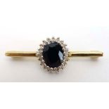 A 9ct yellow gold bar brooch set diamond and sapphire cluster, w. 3.6 cm, 2.
