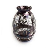 A metalware overlaid clear glass vase of ribbed ovoid form decorated with stylised trees and leaves,