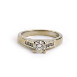 An 18ct white gold ring set brilliant cut diamond in a raised four claw setting,