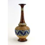 A Doulton Lambeth stoneware bottle vase of slender form typically relief decorated with stylised