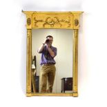 A giltwood wall mirror, the rectangular plate flanked by a pair of acanthus leaf capped pilasters,