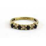 A 9ct yellow gold half eternity ring set four small sapphires interspersed with three diamonds,