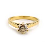 A yellow metal ring set brilliant cut diamond in a six claw setting, stone approximately 1 carat,