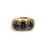 An 18ct yellow gold ring set three sapphire and diamond clusters, ring size Q, 3.