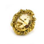 An 18ct yellow gold dress ring set oval citrine within a scrolled and filigree border, ring size K,