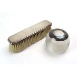 A silver backed hairbrush and a silver mounted match holder/striker,