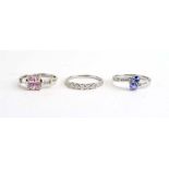 A 9ct white gold crossover ring set two tanzanite coloured stones and small diamonds,
