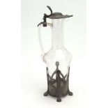 An early 20th century glass jug mounted in pewter in the Art Nouveau manner, h.